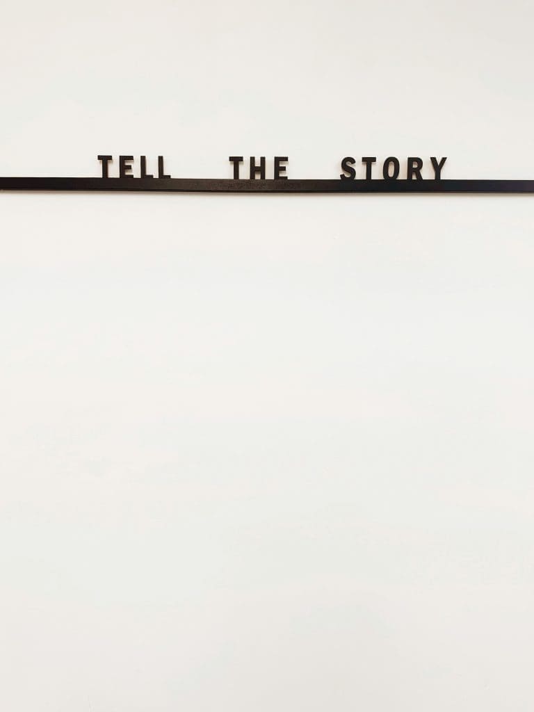black underlined text that says "tell the story"
