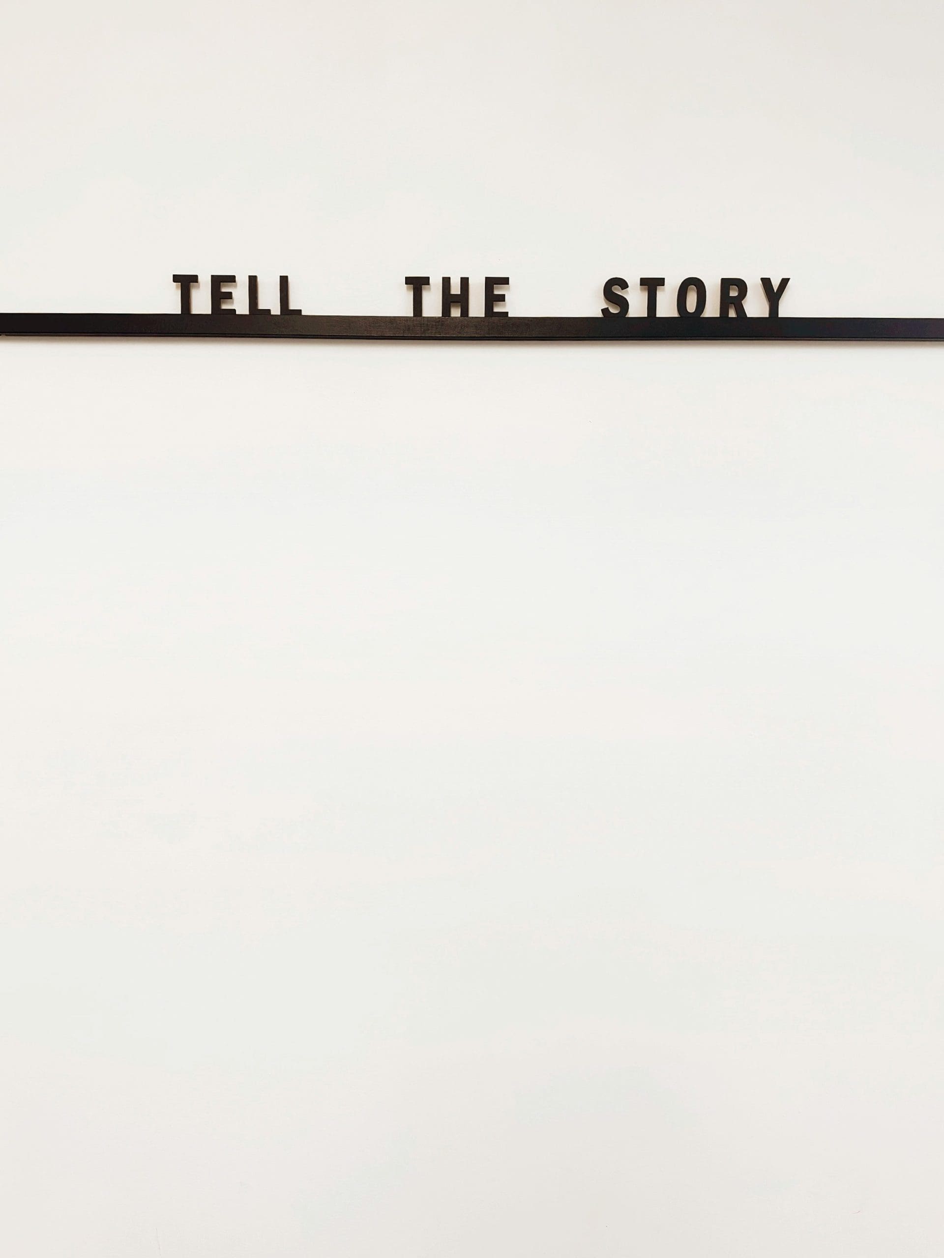 black underlined text that says "tell the story"